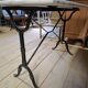 Pair of bistro tables in marble and cast iron.