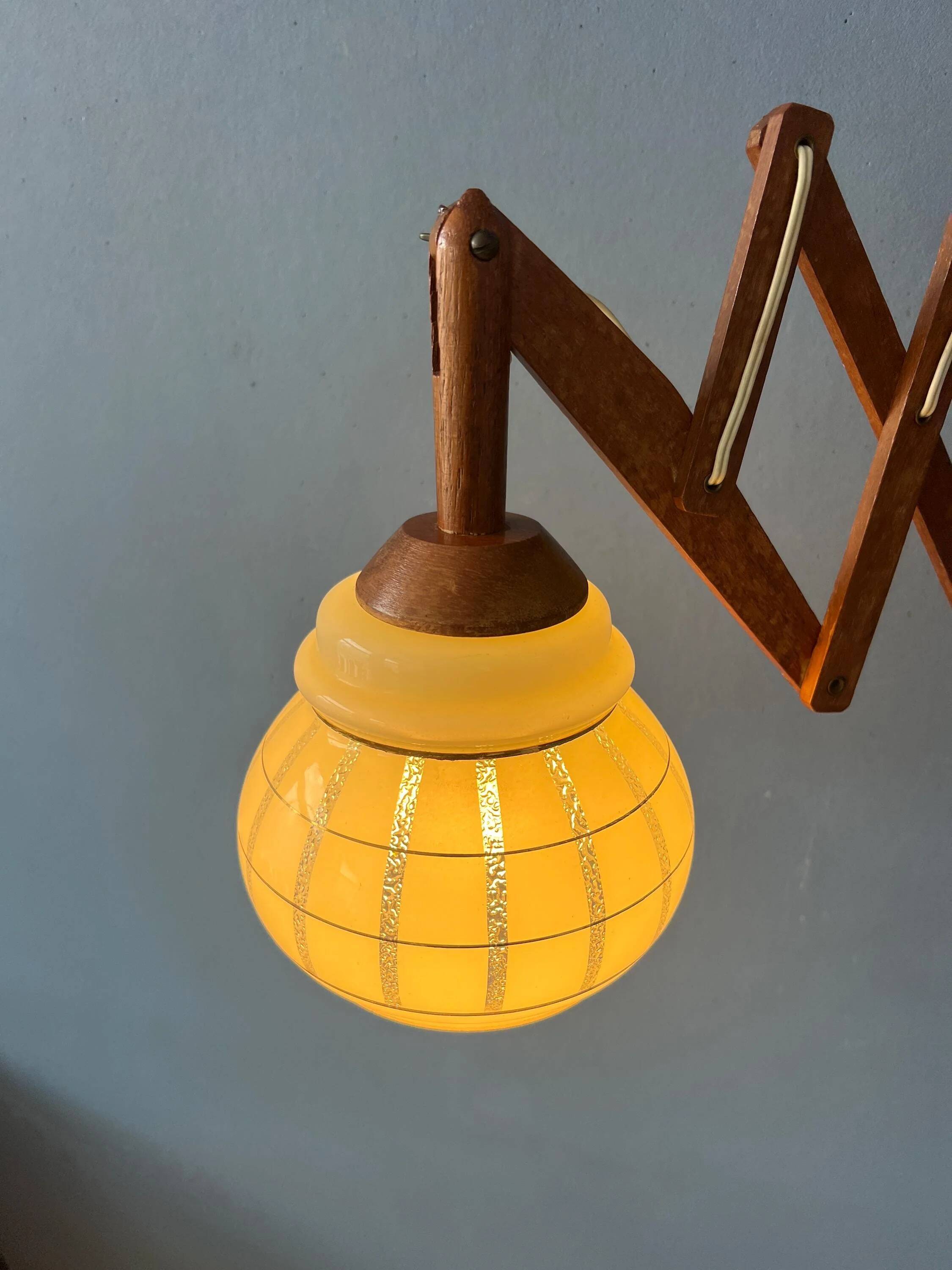 Vintage wall lamp with teak wood scissors and glass shade.