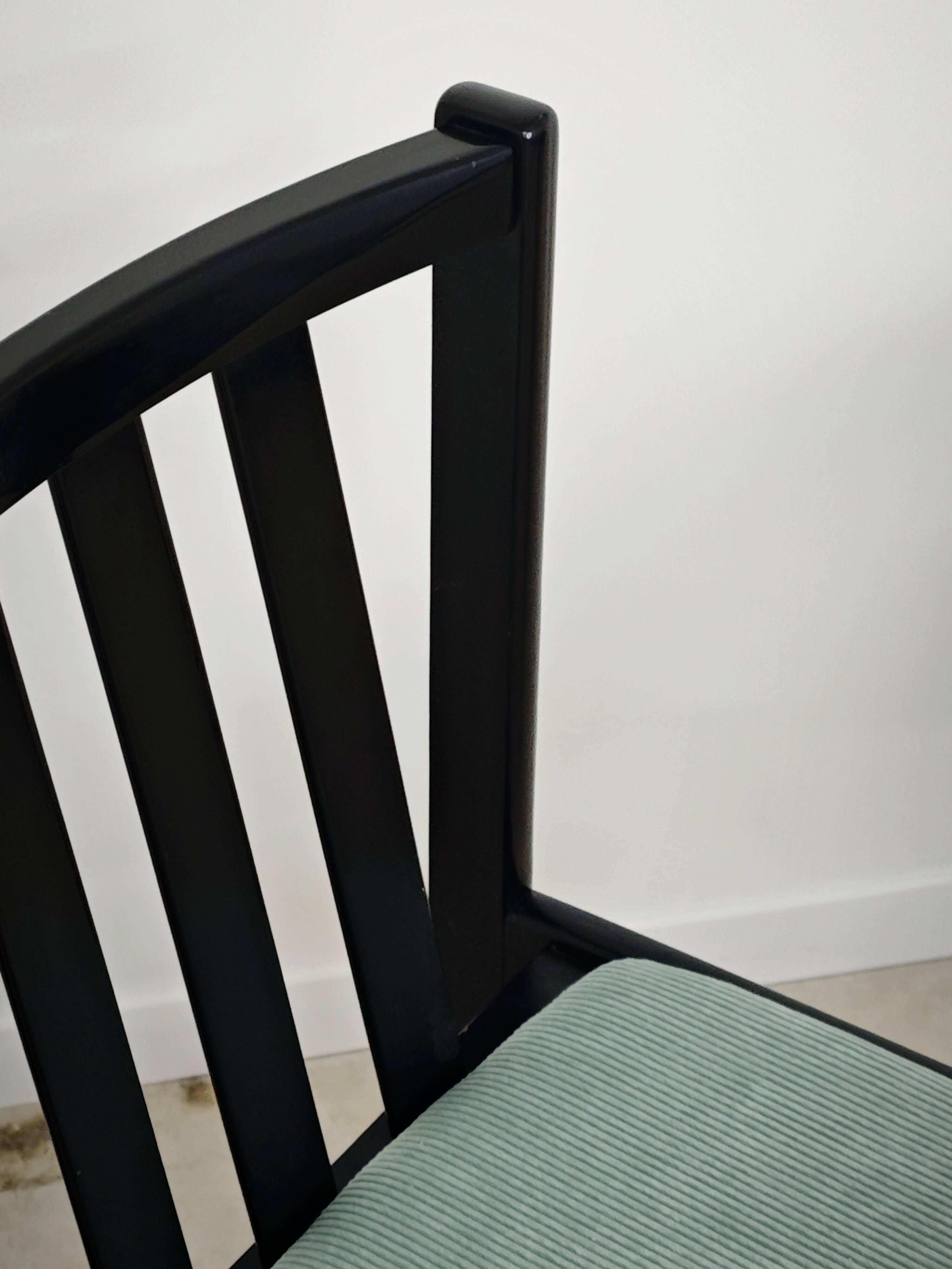 Set of 6 modernist black chairs with light blue-green ribbed fabric.