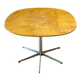 Dining table with a star-shaped six-legged base by Arne Jacobsen for Fritz Hansen.
