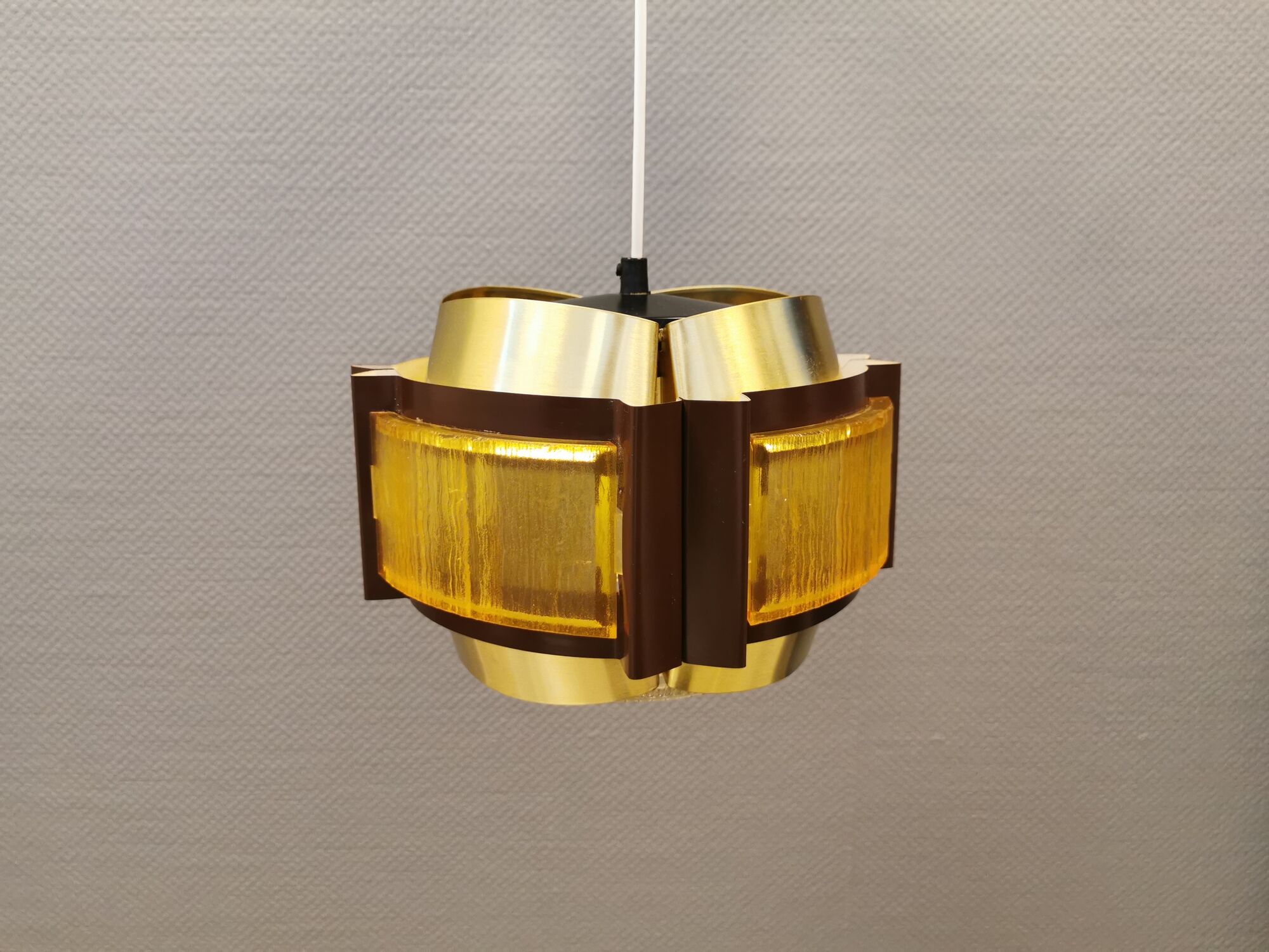 Danish hanging lamp, made in brass colored and brown metal, with yellowish hard pressed plastic deta