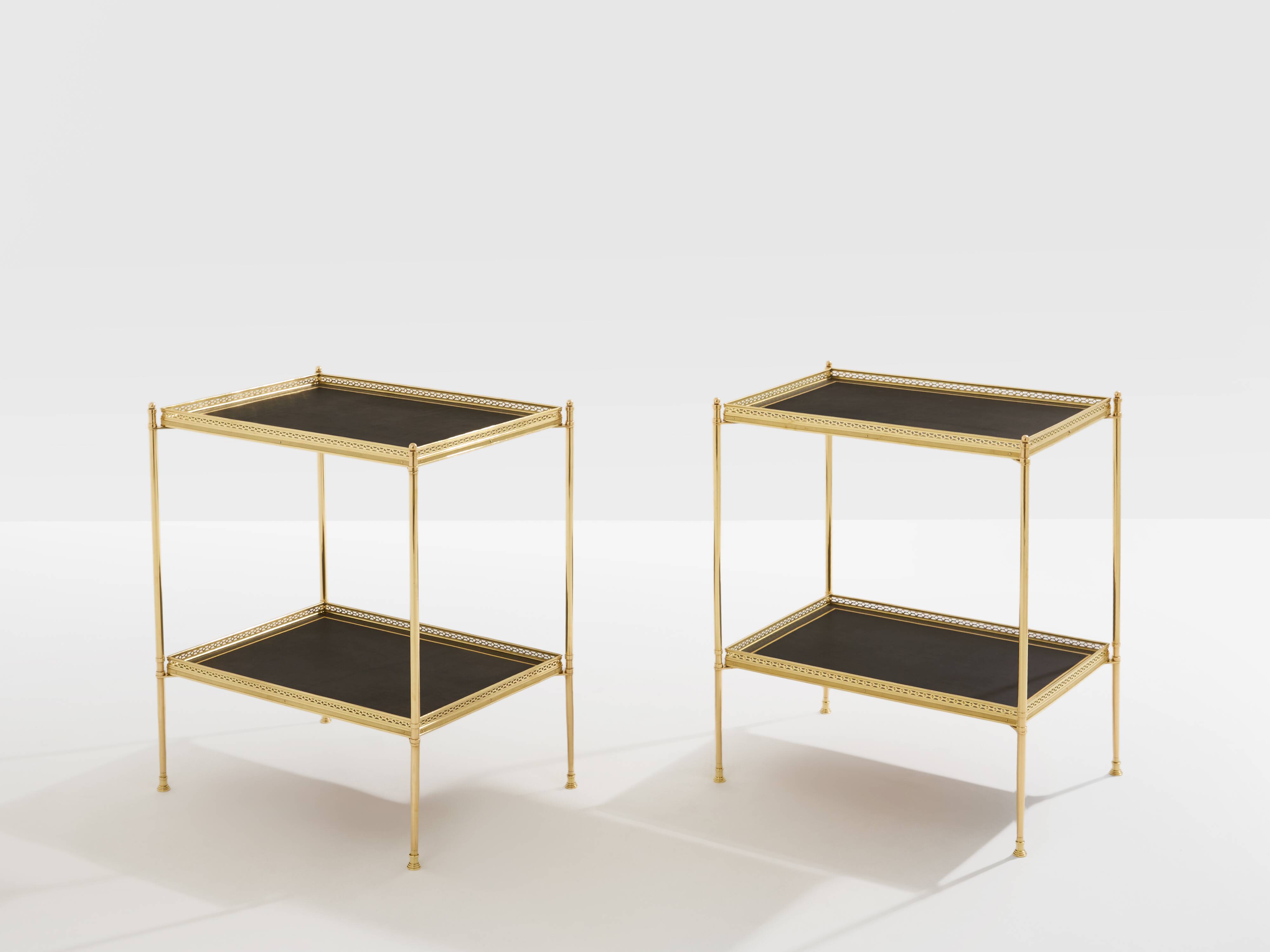 Pair of neoclassical side tables in brass and black leather by Maison Jansen, 1960.