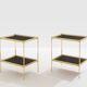 Pair of neoclassical side tables in brass and black leather by Maison Jansen, 1960.