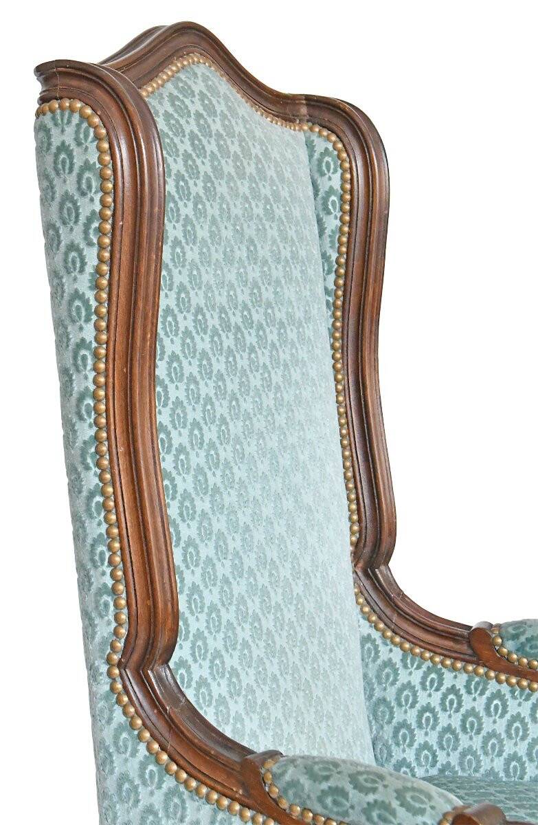 Pair of Louis XV style wingback armchairs with five legs.