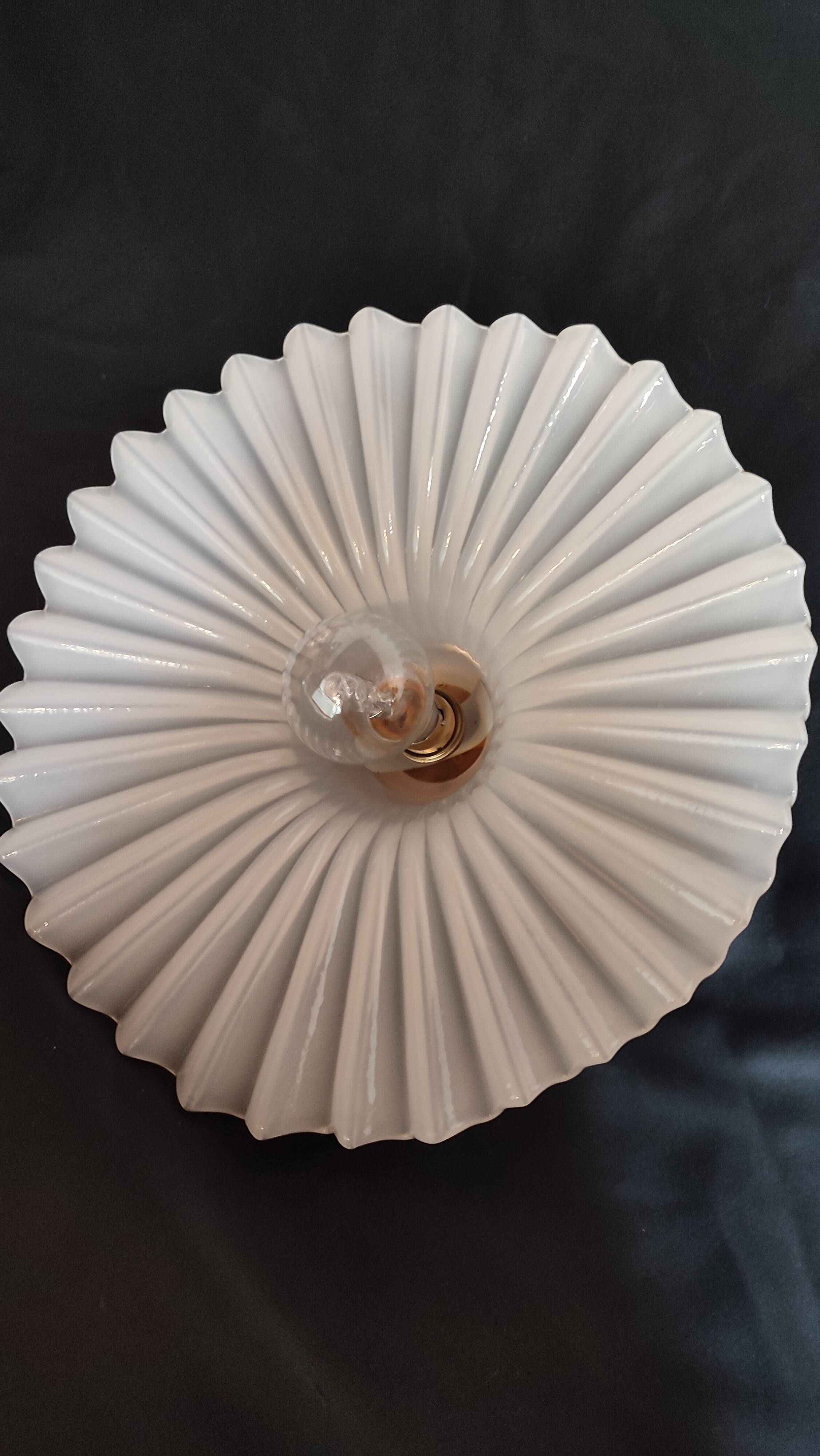Round pendant light in pleated semi-opaque glass