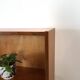 Deens teak vakkenkast met lades en hoge poten, vintage wandkast