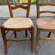 2 solid oak carved and rush-seated chairs in the Louis Philippe style, 19th century.
