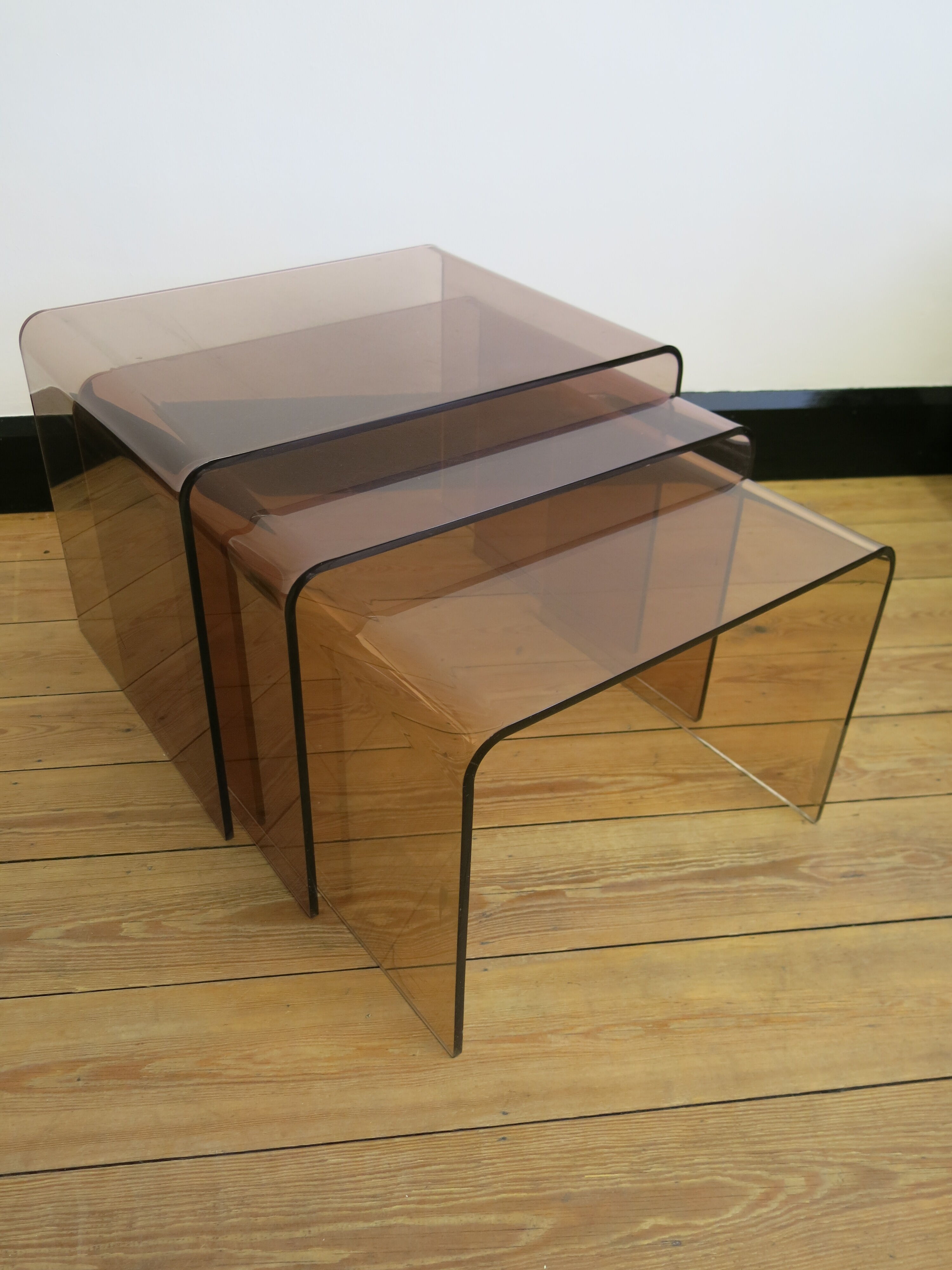 Trio of plexi nesting tables signed Michel Dumas