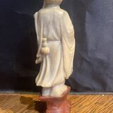Soapstone sculpture on obsidian base of a Buddhist.