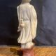 Soapstone sculpture on obsidian base of a Buddhist.