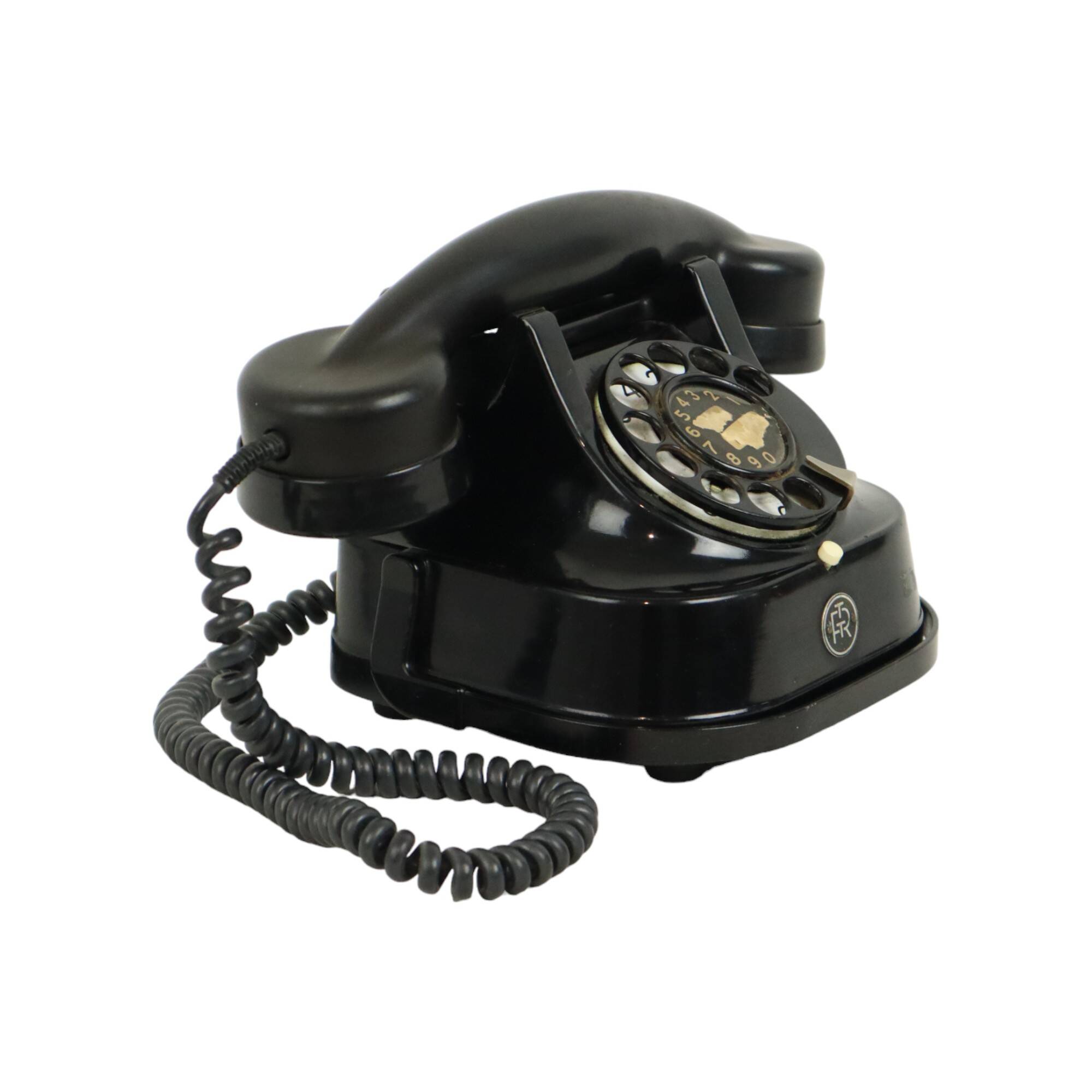 Old black telephone with rotary dial metal Bakelite RTT 56B