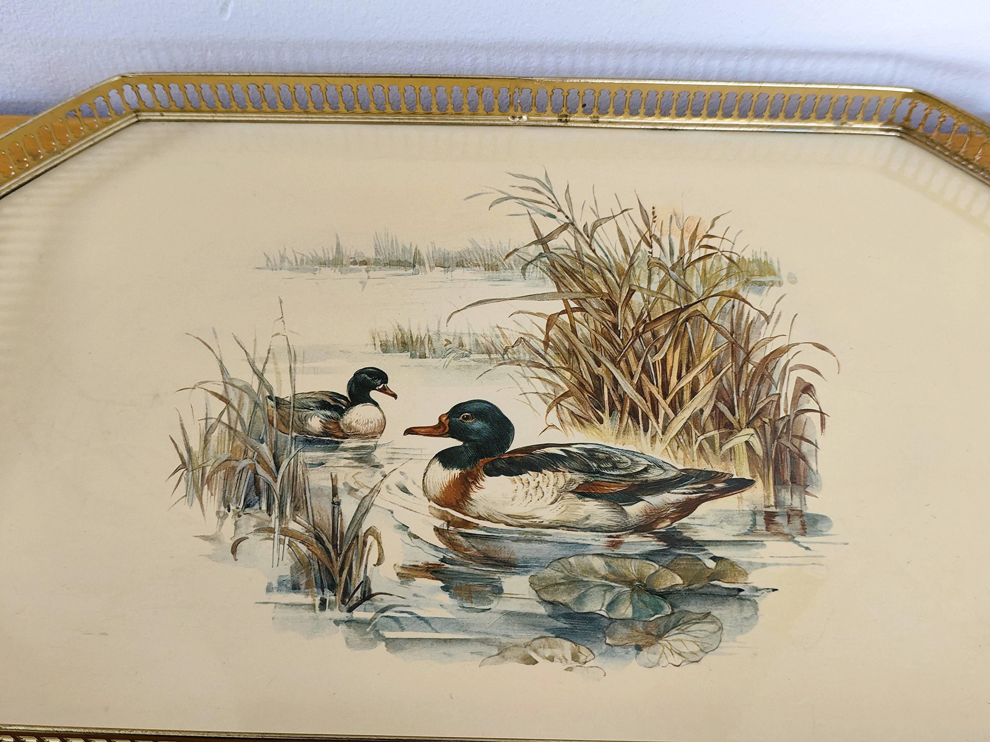 Vintage service tray with a golden gallery and mirror, decorated with ducks.