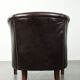 Dark cow leather club armchair with a stylish design in English style