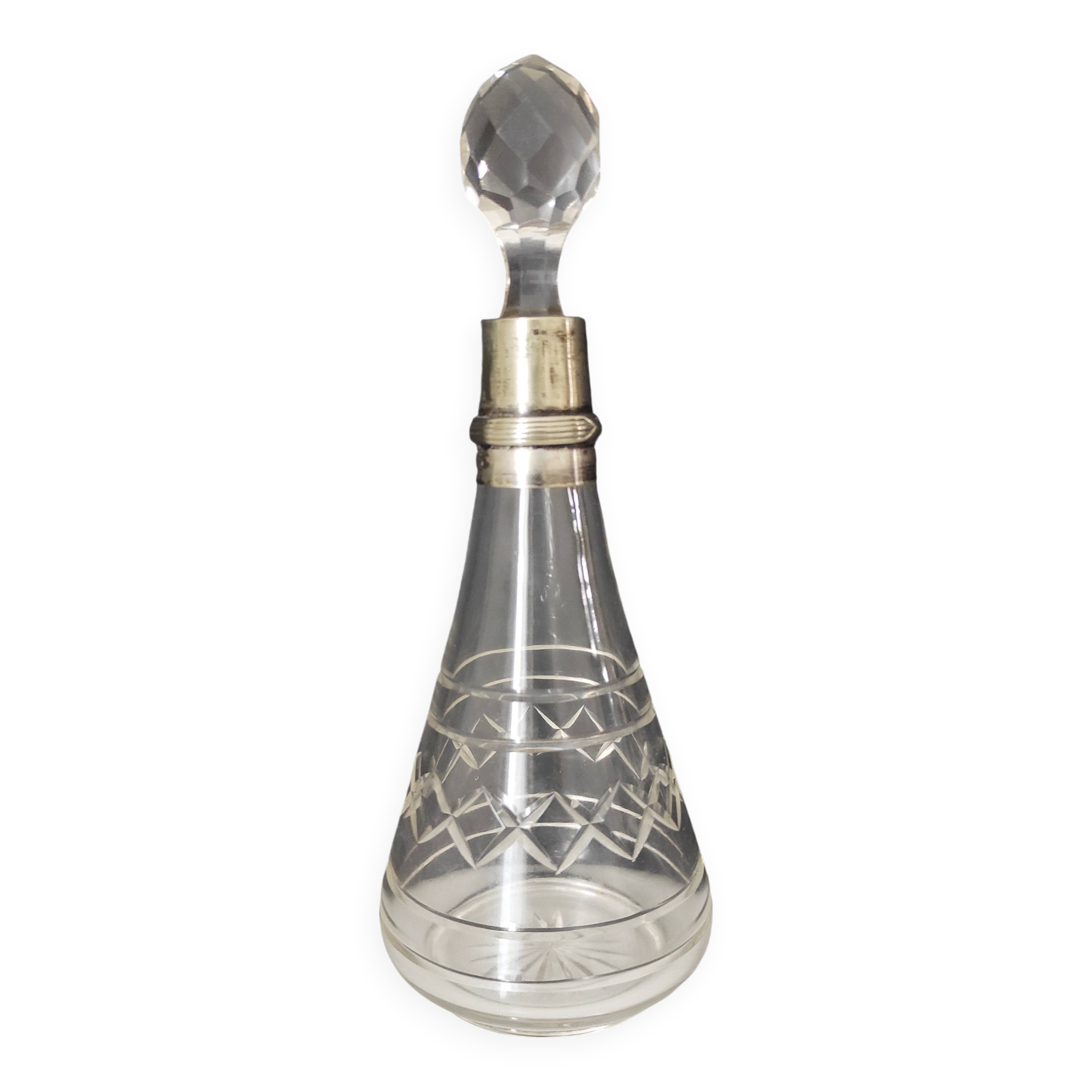 Crystal bottle with silver metal neck rim