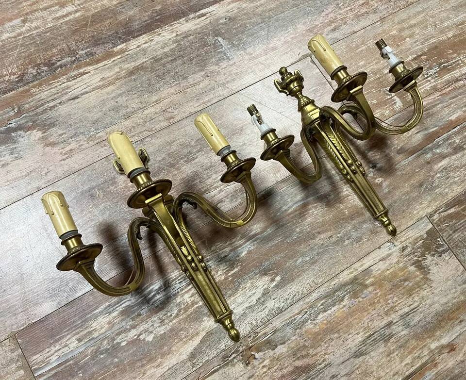 Pair of Louis XVI style gilt bronze wall lights with two light arms, 20th century