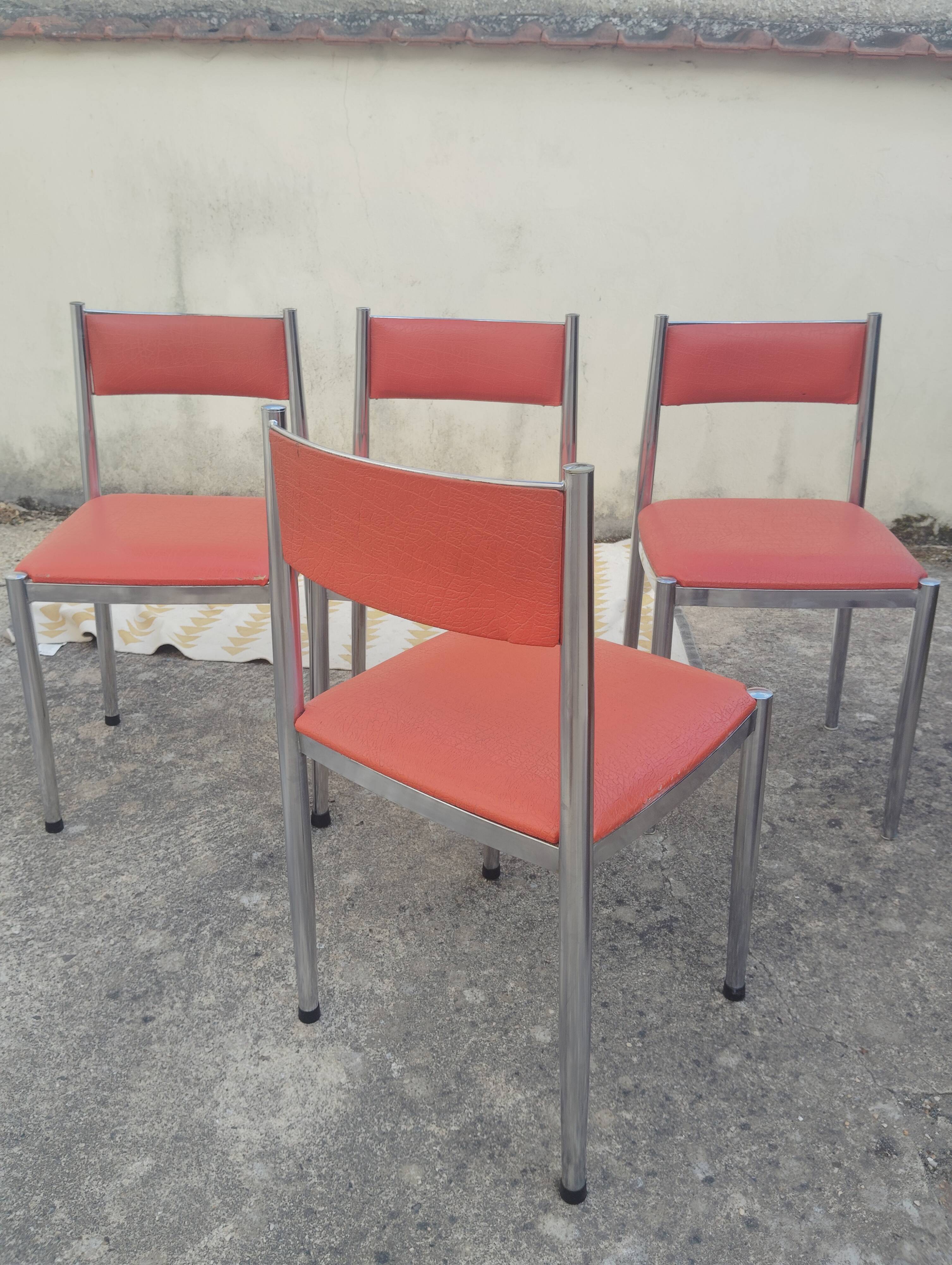 Set of 4 vintage chrome and orange faux leather chairs.