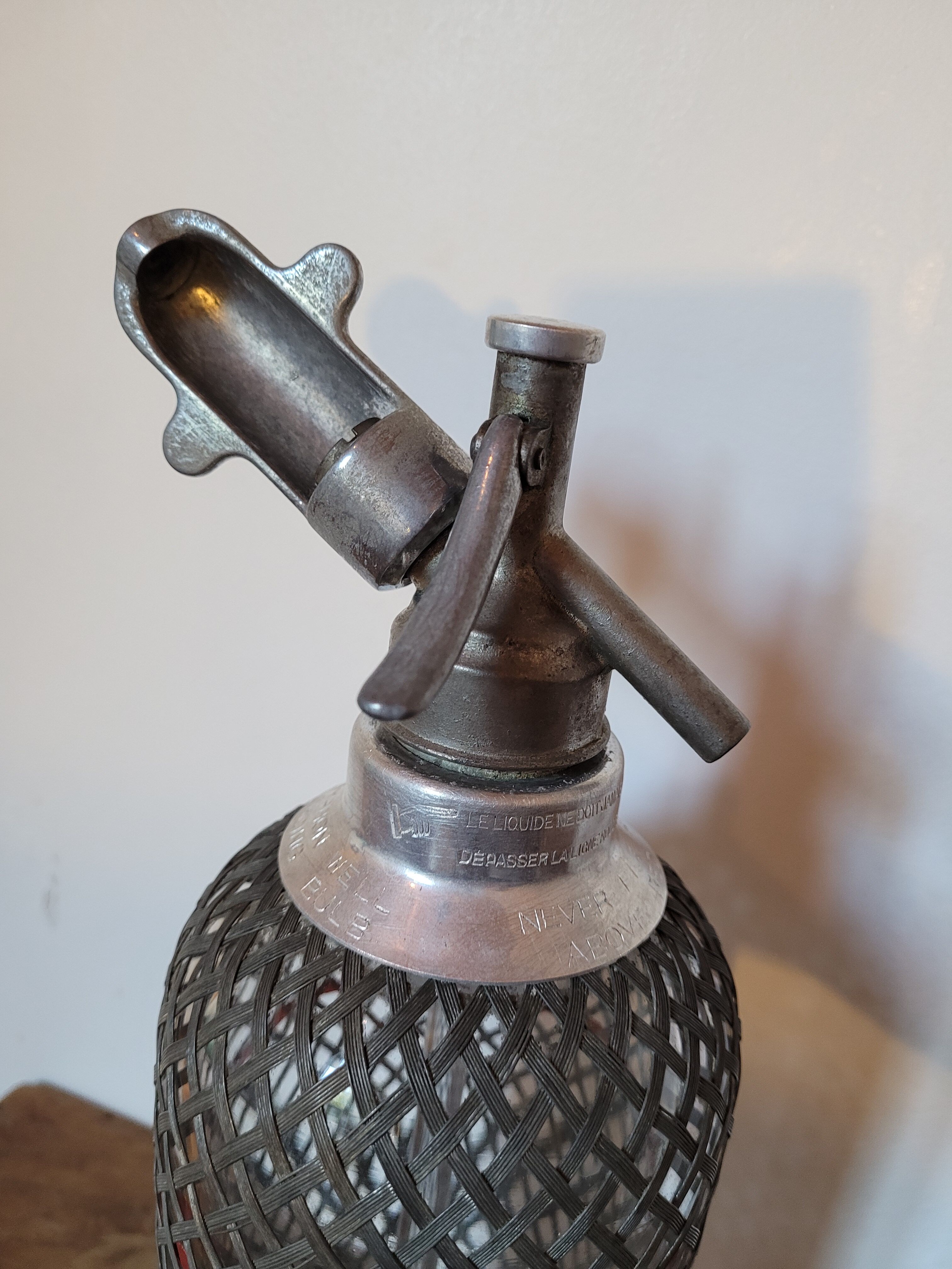 Old glass and metal siphon