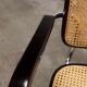 Fauteuil b64 Breuer noir cannage accoudoirs et tampons neufs
