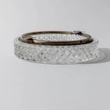 Vintage crystal glass ashtray from the 1920s, silver-edged with a textured pattern, Art Deco table decoration.