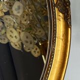 Oval-shaped gilded wooden mirror