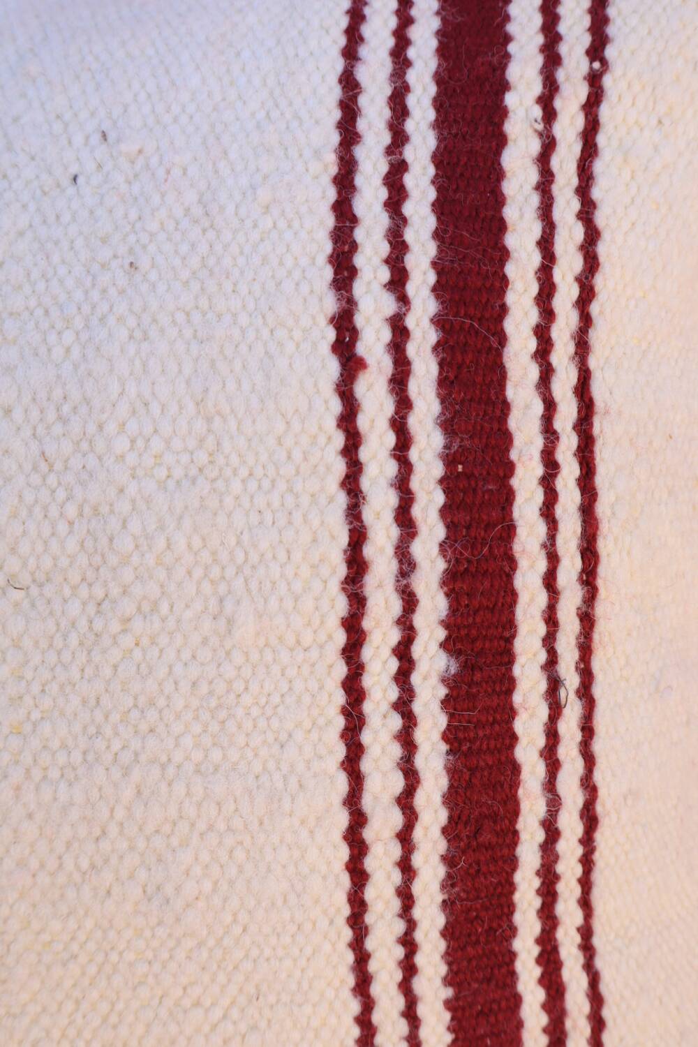 burgundy and white striped cushion in handmade wool