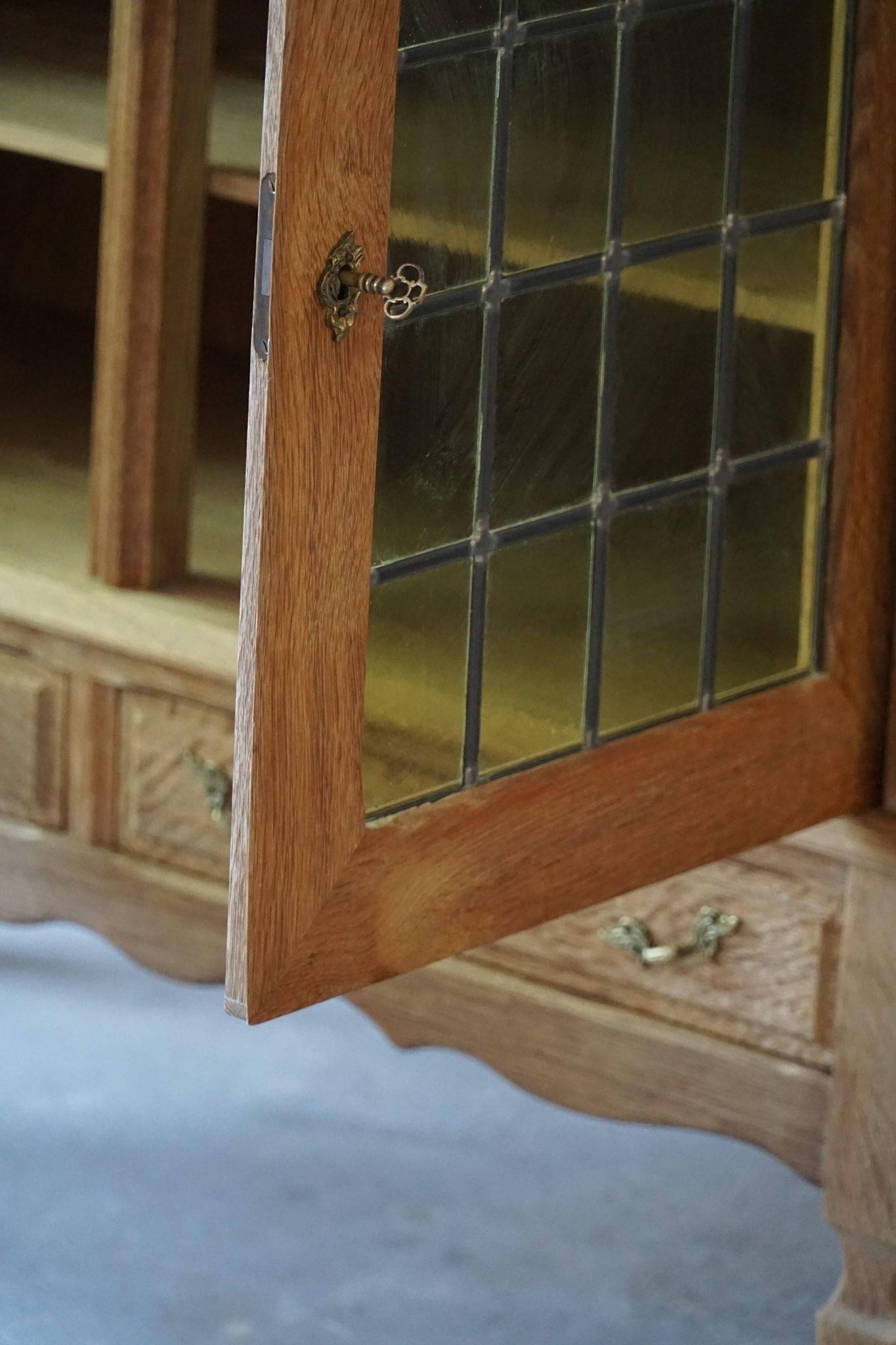 20th-century mid-century solid oak sideboard with glass front, by a Danish cabinetmaker.