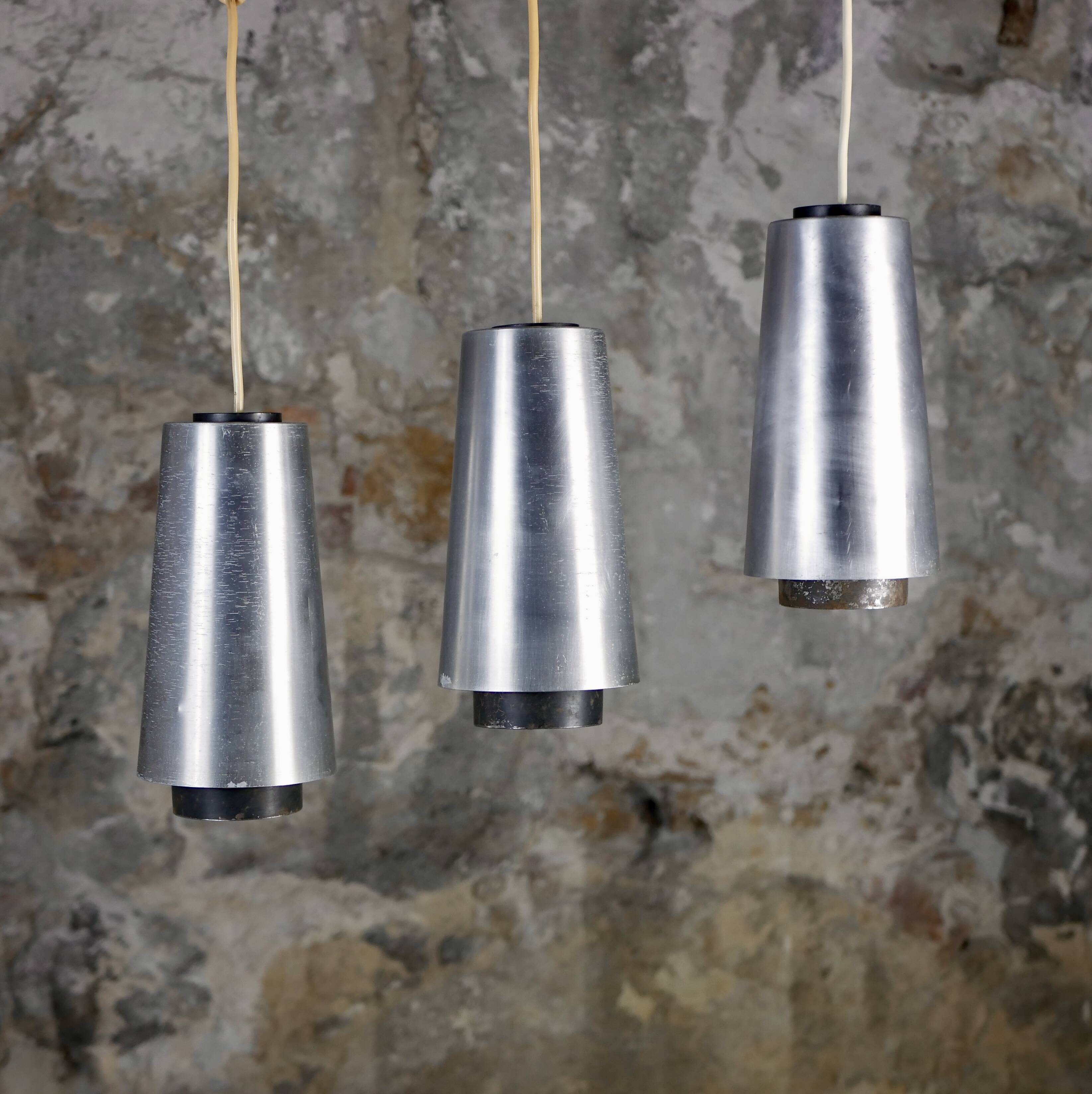 Trio of Raak steel pendant lights, 1960s