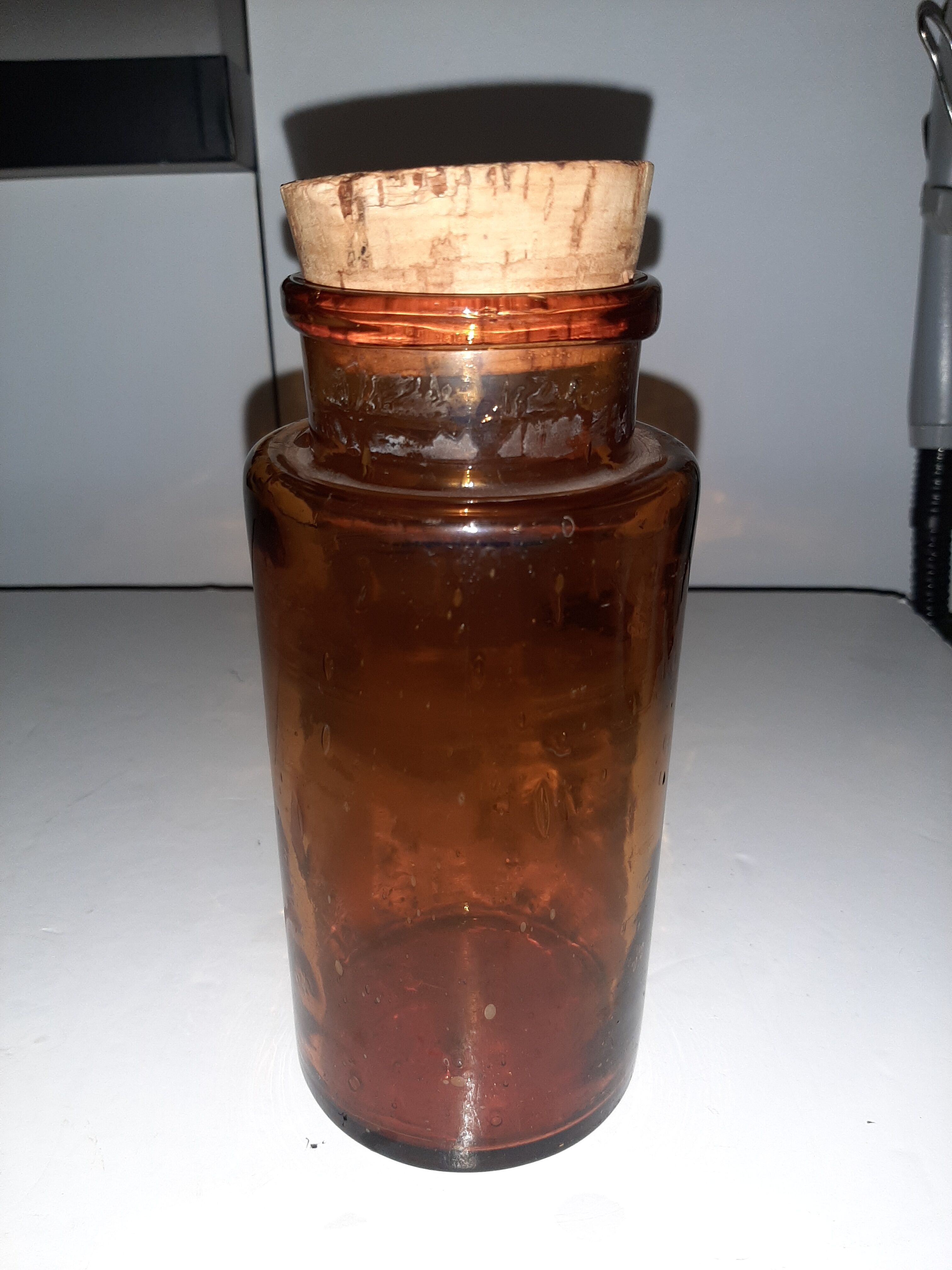 Amber pharmacy bottle made of old bubbled glass