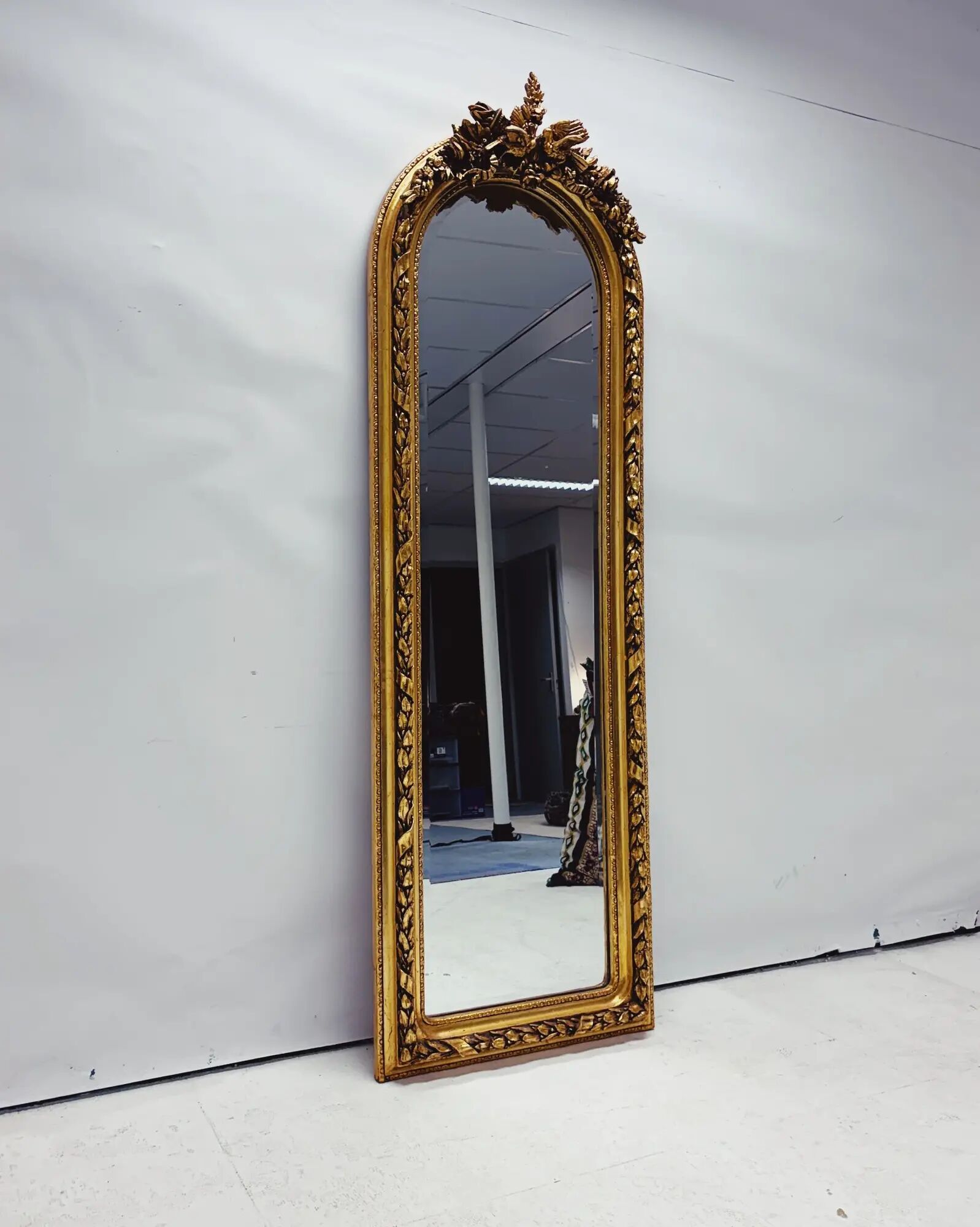 Large gold full-length mirror with ornate crest