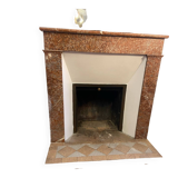 Marble fireplace surround with closed hearth frame.