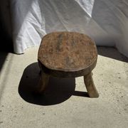 Small stool, oval solid teak side table with curved legs in wabi-sabi style.