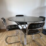 ensemble composé d'une table en chrome et verre fumé et ses 4 chaises tubulaires en chrome et skaï a