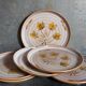 Six assiettes en grès de Niderviller au décor végétal vintages