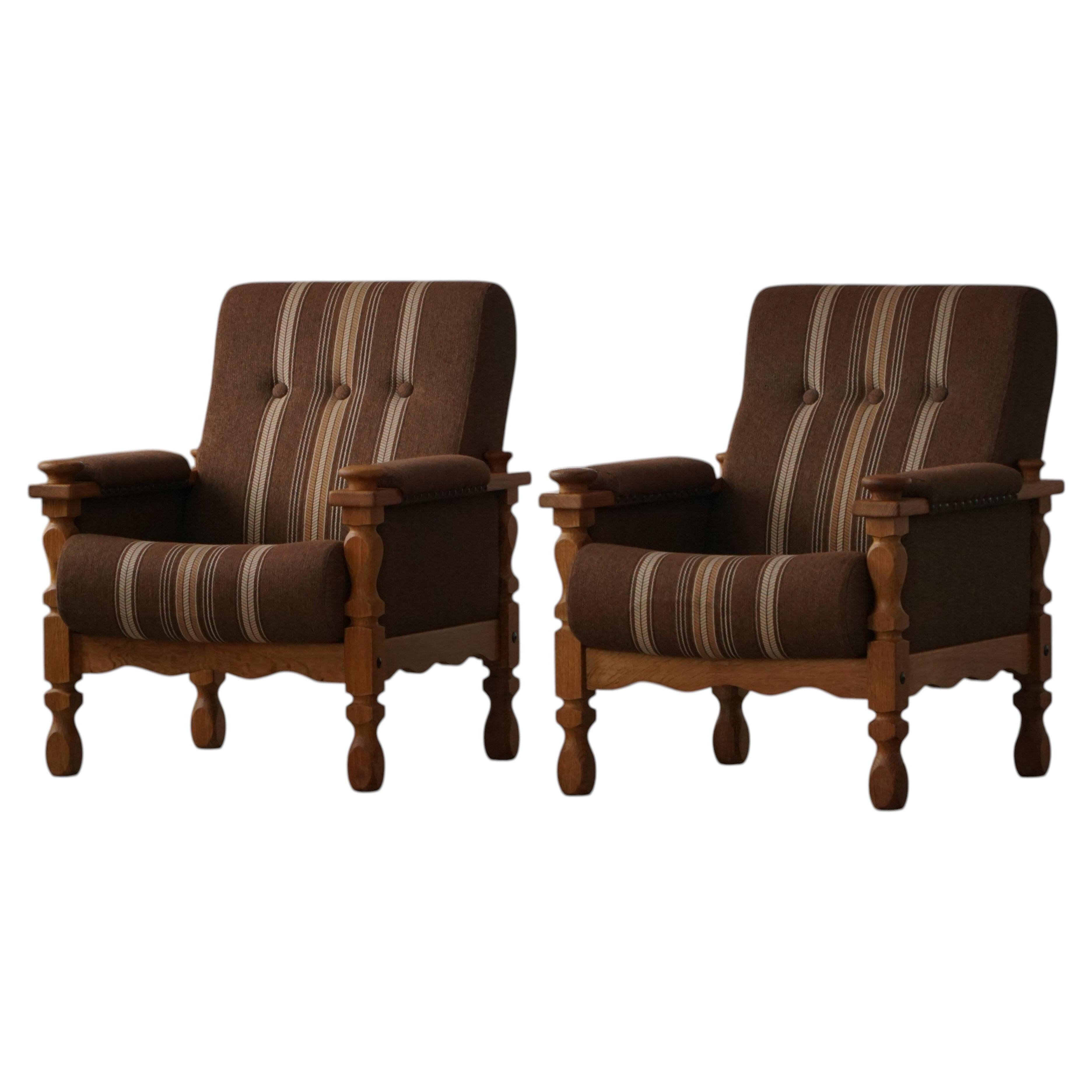 Modern Danish, a pair of lounge chairs in oak and wool, Henning Kjærnulf, 1960s.