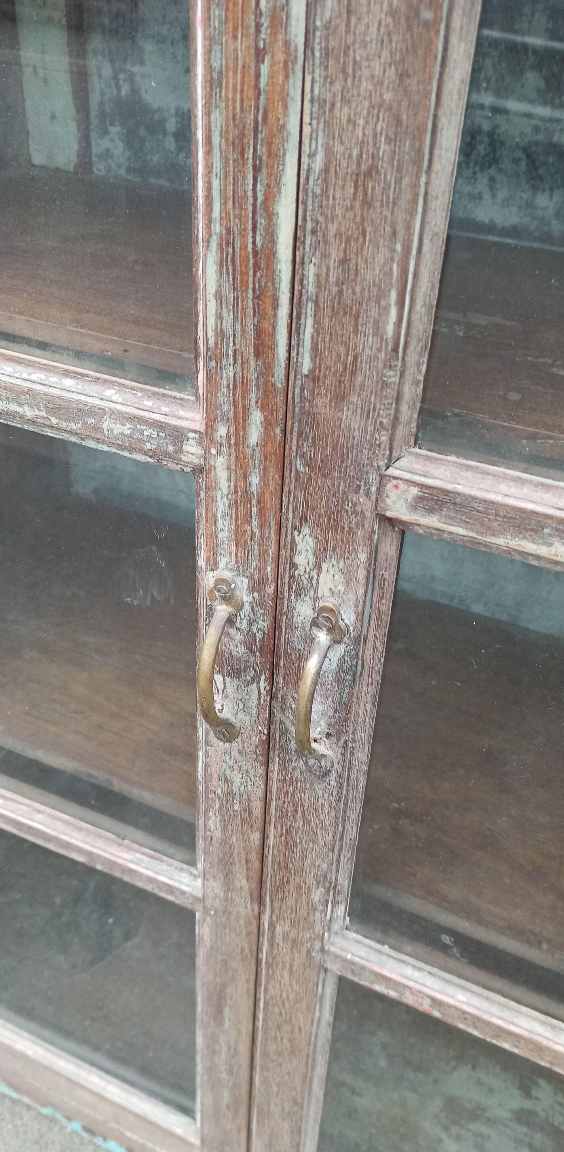 Old glazed wooden cabinet with metal bottom