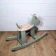 Green and beige wooden rocking horse