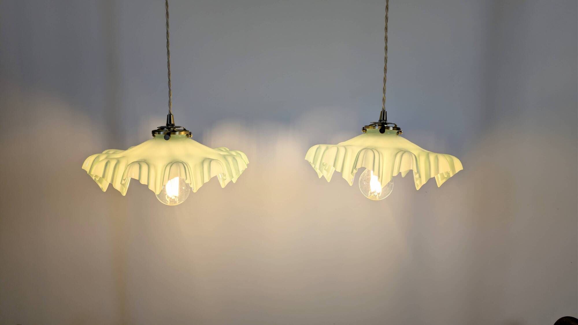 Pair of green opaline glass pendant lights – frosted poetry & Art Deco brilliance