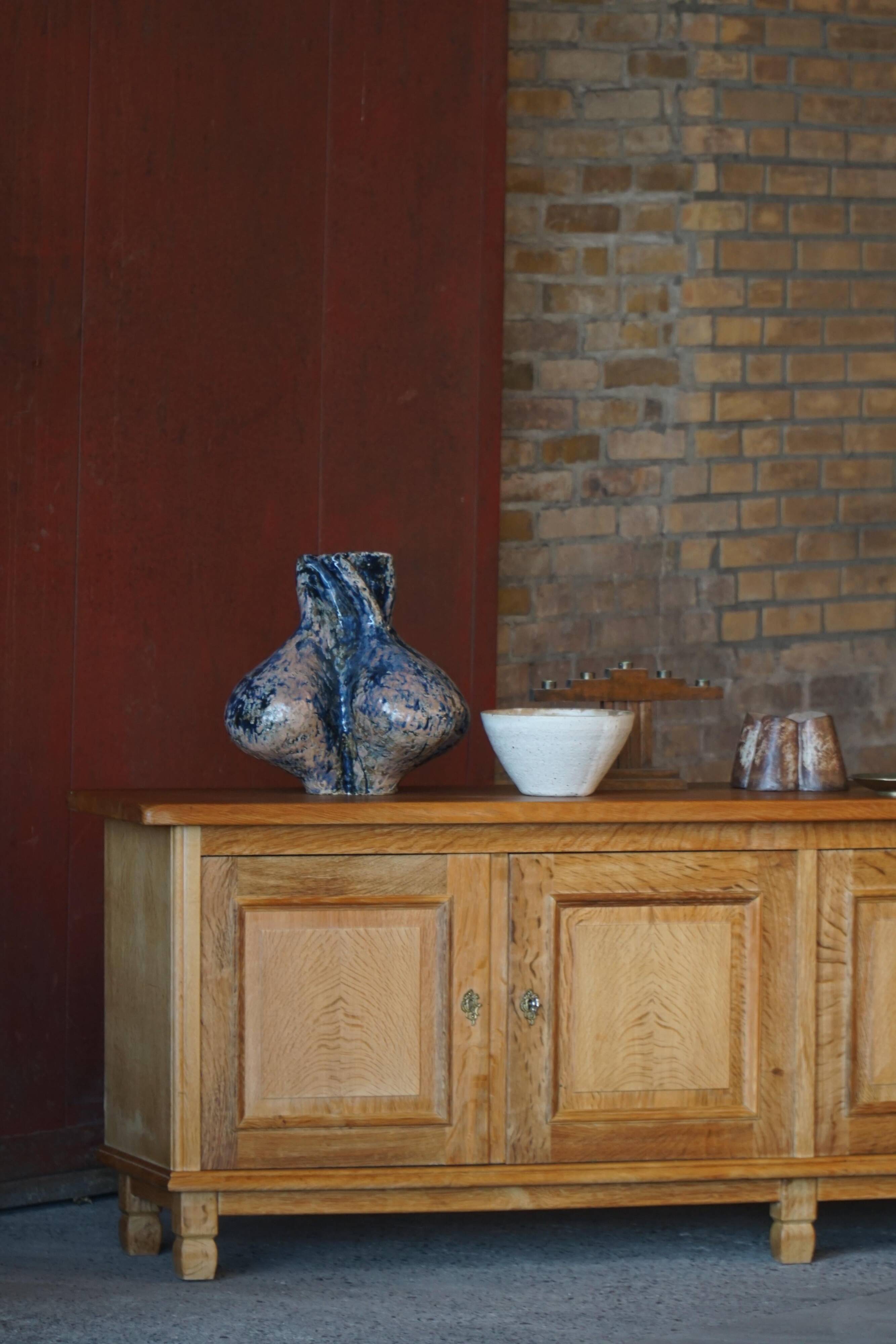 Modern Danish low enfilade in oak with panelled doors, mid-20th century.