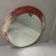 Vintage round mirror with an industrial metal frame in a painted finish.