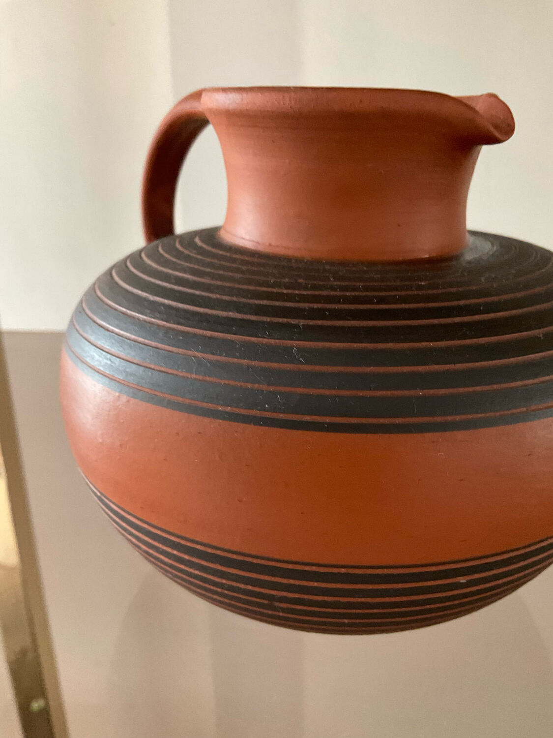 Vintage jug in chiseled terracotta