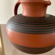 Vintage jug in chiseled terracotta