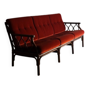 Dark rattan 3-seater sofa with red velour cushions | 1980s