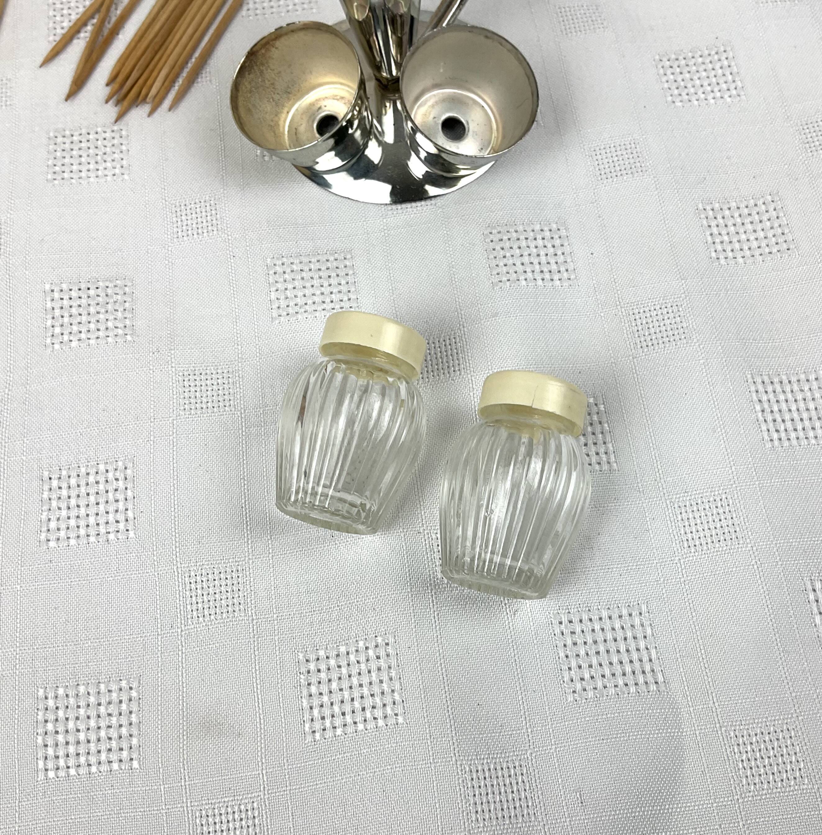 Vintage salt and pepper shakers and their chrome metal support