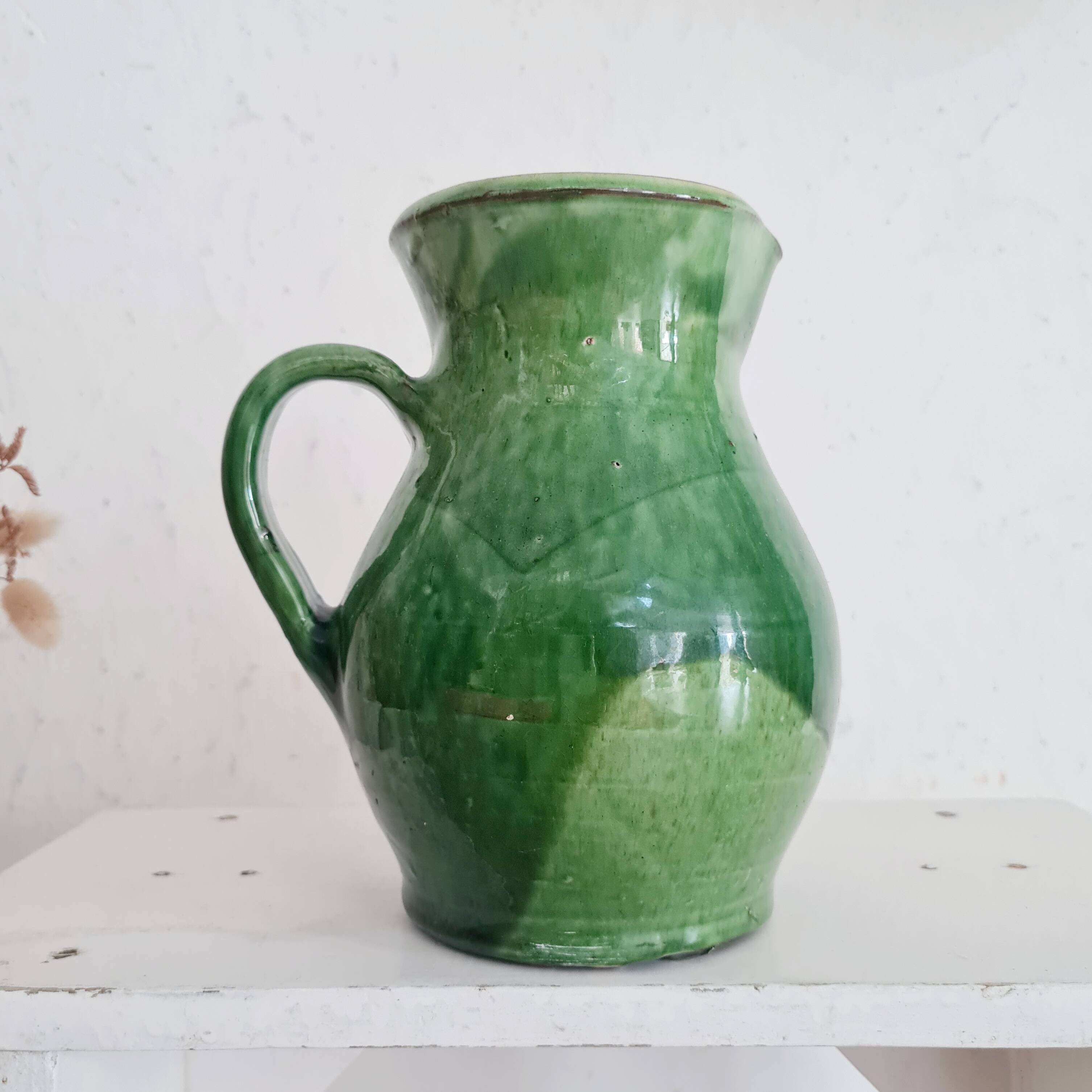 Antique green pitcher in painted terracotta