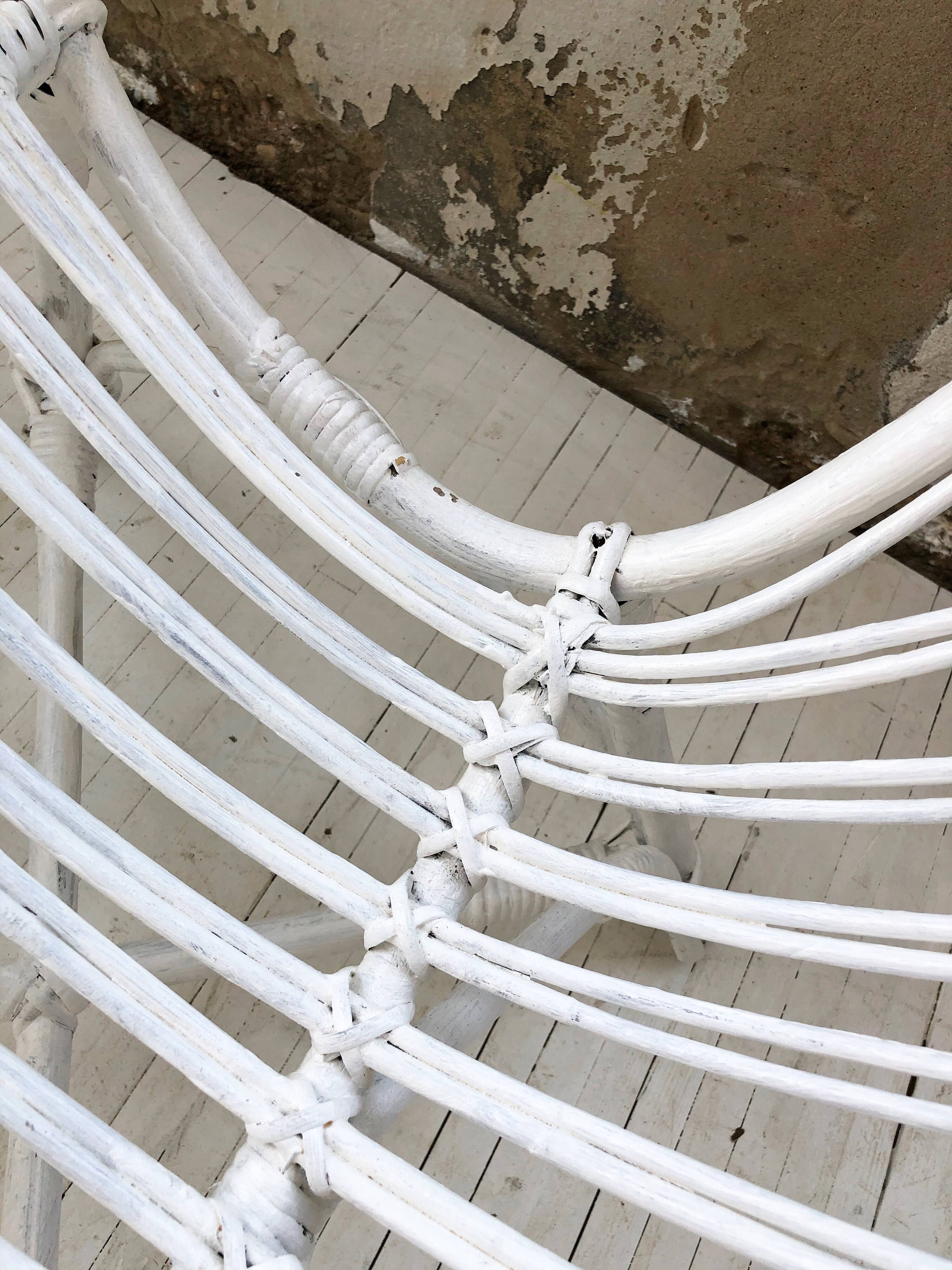 Pair of white rotin armchairs