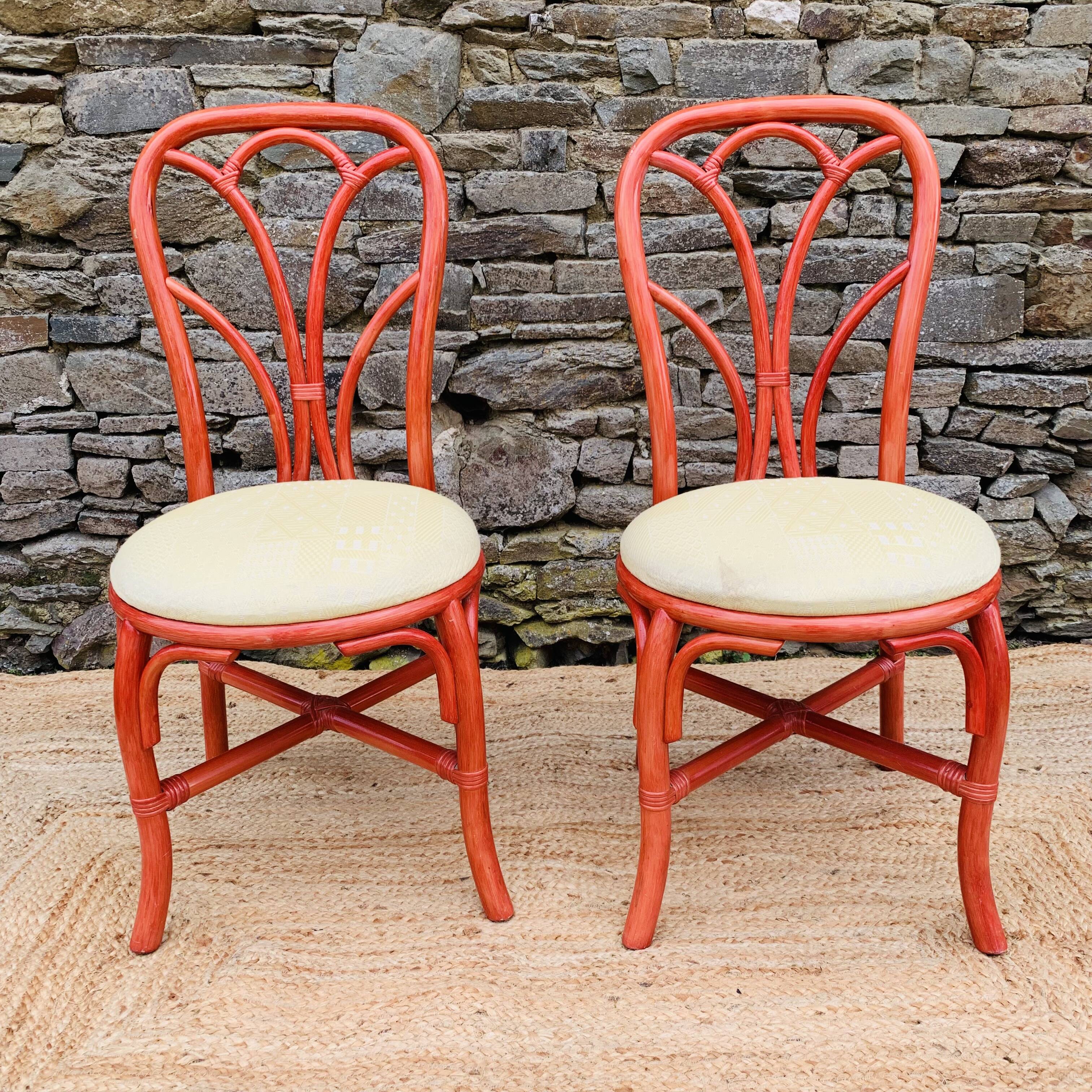 Pair of red rattan chairs and fabric
