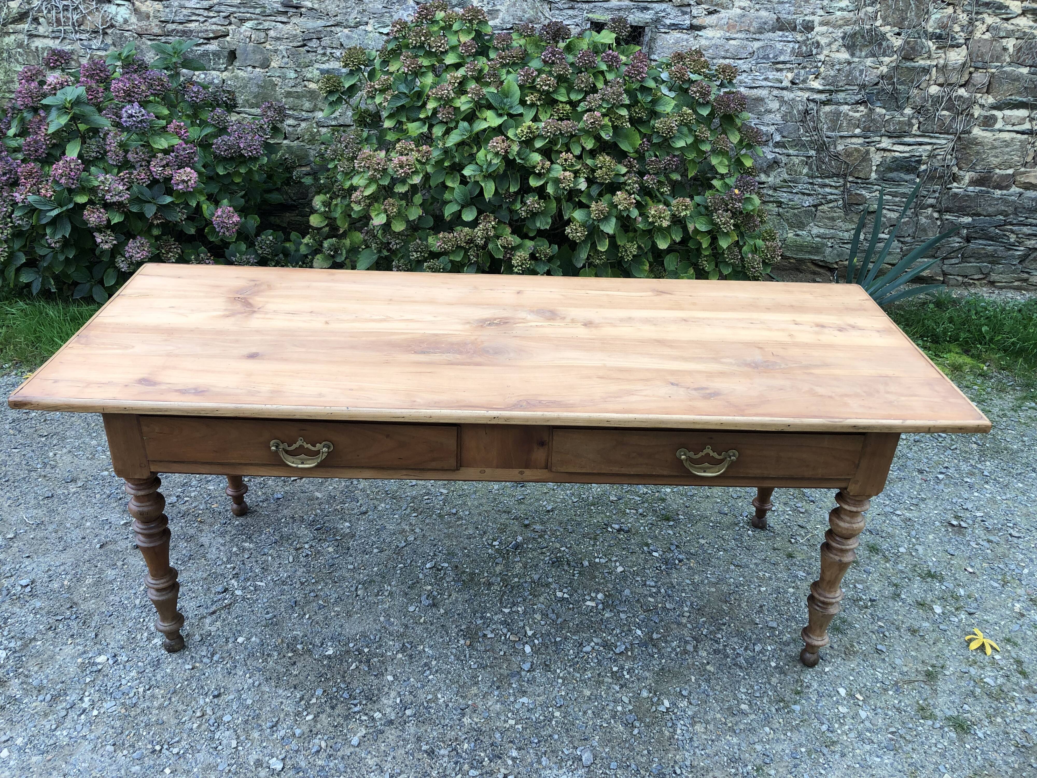 Antique Louis Philippe style farm table in solid cherry wood with 2 drawers and turned base.