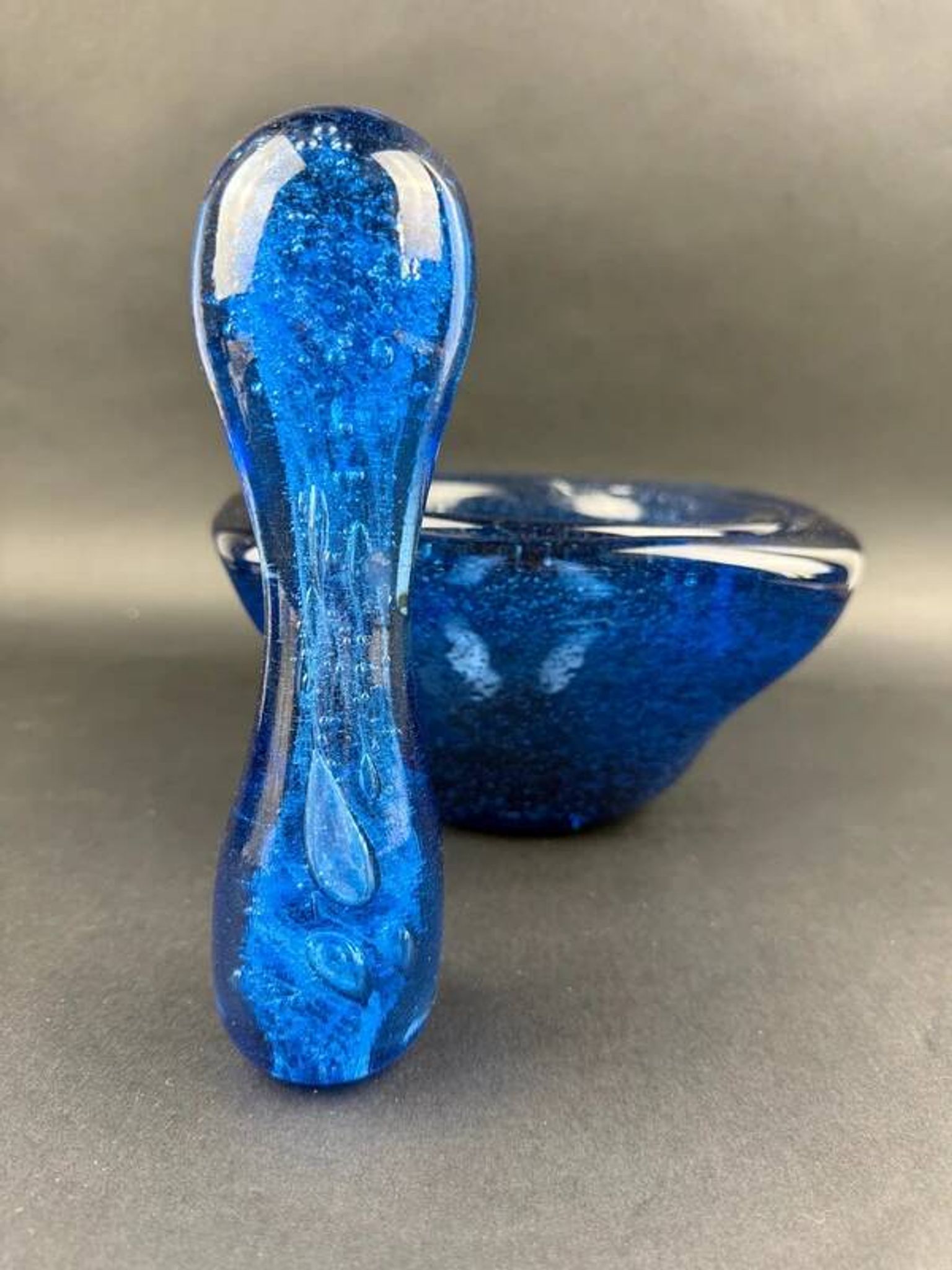 Mortar and pestle in the style of Biot, hard blue.