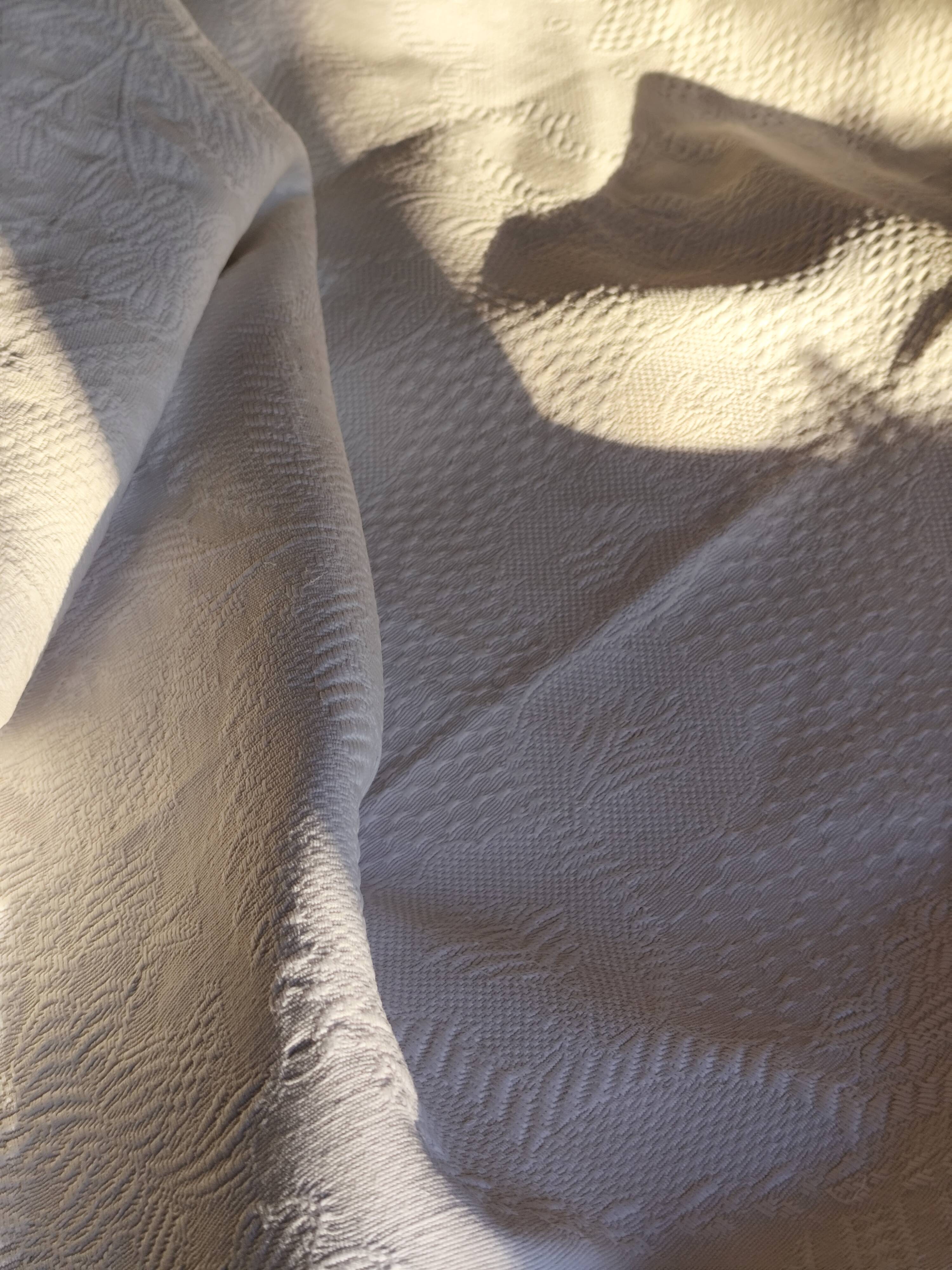 White woven cotton bedspread with fringes