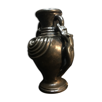 Black ceramic vase caught in naked women's bodies